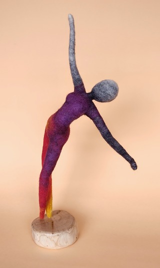 joy - a lithe, elegant needlefelt artdoll in flame colours. she is a dancer reaching out with an upward gaze